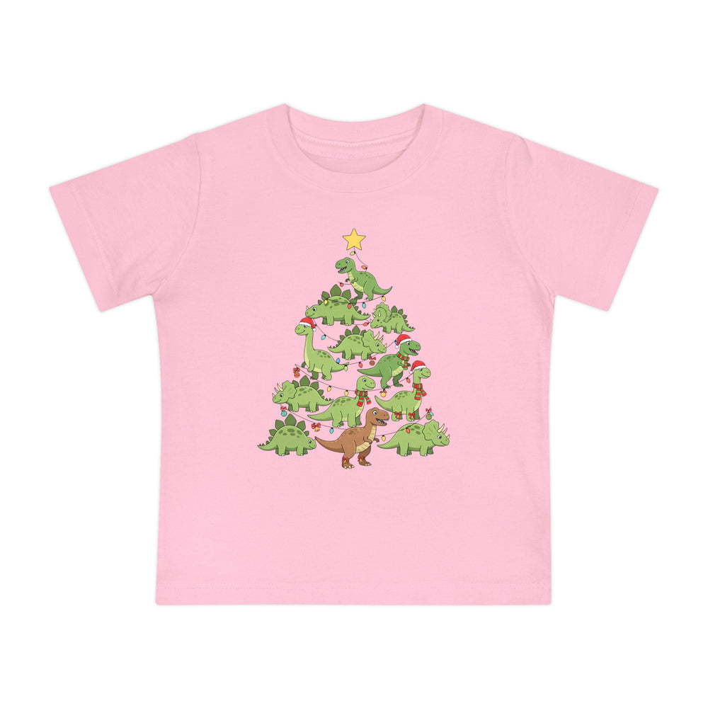 Dino Tree Baby Tee: Light pink children's T-shirt with green cartoon dinosaurs forming a Christmas tree, adorned with holiday lights, ornaments, scarves, and Santa hats.