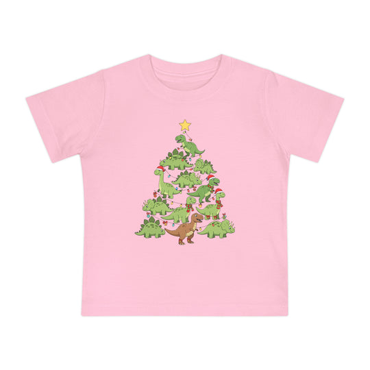 Dino Tree Baby Tee: Light pink children's T-shirt with green cartoon dinosaurs forming a Christmas tree, adorned with holiday lights, ornaments, scarves, and Santa hats.