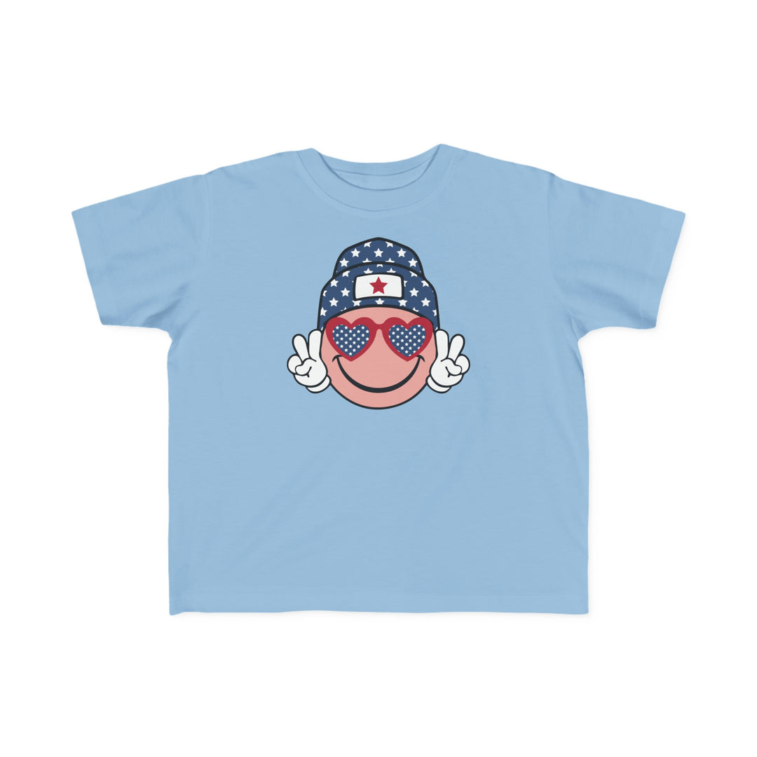 American Girl Toddler Tee featuring a cartoon face and sunglasses, perfect for sensitive skin. 100% combed ringspun cotton, tear-away label, classic fit. Sizes: 2T, 3T, 4T, 5-6T.