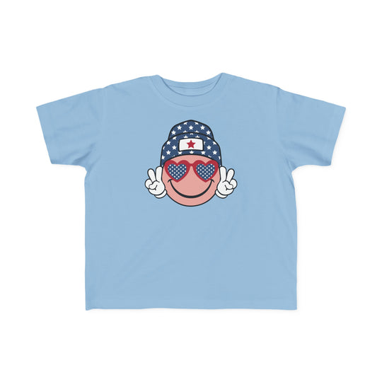 American Girl Toddler Tee featuring a cartoon face and sunglasses, perfect for sensitive skin. 100% combed ringspun cotton, tear-away label, classic fit. Sizes: 2T, 3T, 4T, 5-6T.