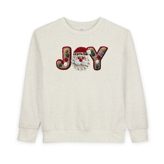 Joy Toddler Crew sweatshirt with JOY motif, featuring a crocheted Santa face for O, offers warmth and style for toddlers.