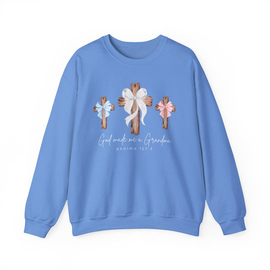 Light-blue sweatshirt with three wooden crosses and bows, God Made Me a Grandma text, Psalm 127:3. Unisex, comfortable blend, ribbed collar.