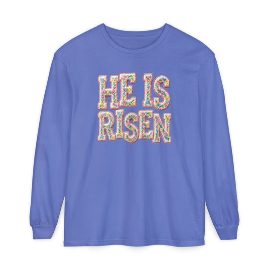He is Risen Long Sleeve Tee in periwinkle blue with floral-patterned letters, offering a relaxed fit and soft, 100% ring-spun cotton fabric.