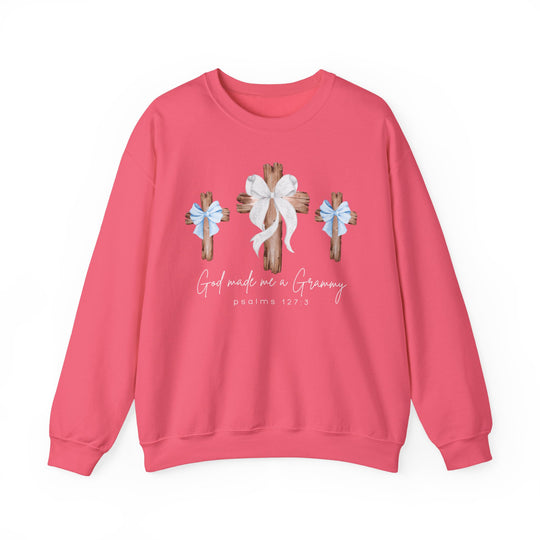 Pink crewneck sweatshirt featuring three wooden crosses and 'God made me a Grammy' text, ideal for comfort with a blend of cotton and polyester.