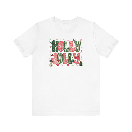Holly Jolly Tee: White crew-neck T-shirt with festive HOLLY JOLLY graphic, featuring candy-cane-and-plaid letters, holiday icons, and snowflakes for a cheerful Christmas vibe.