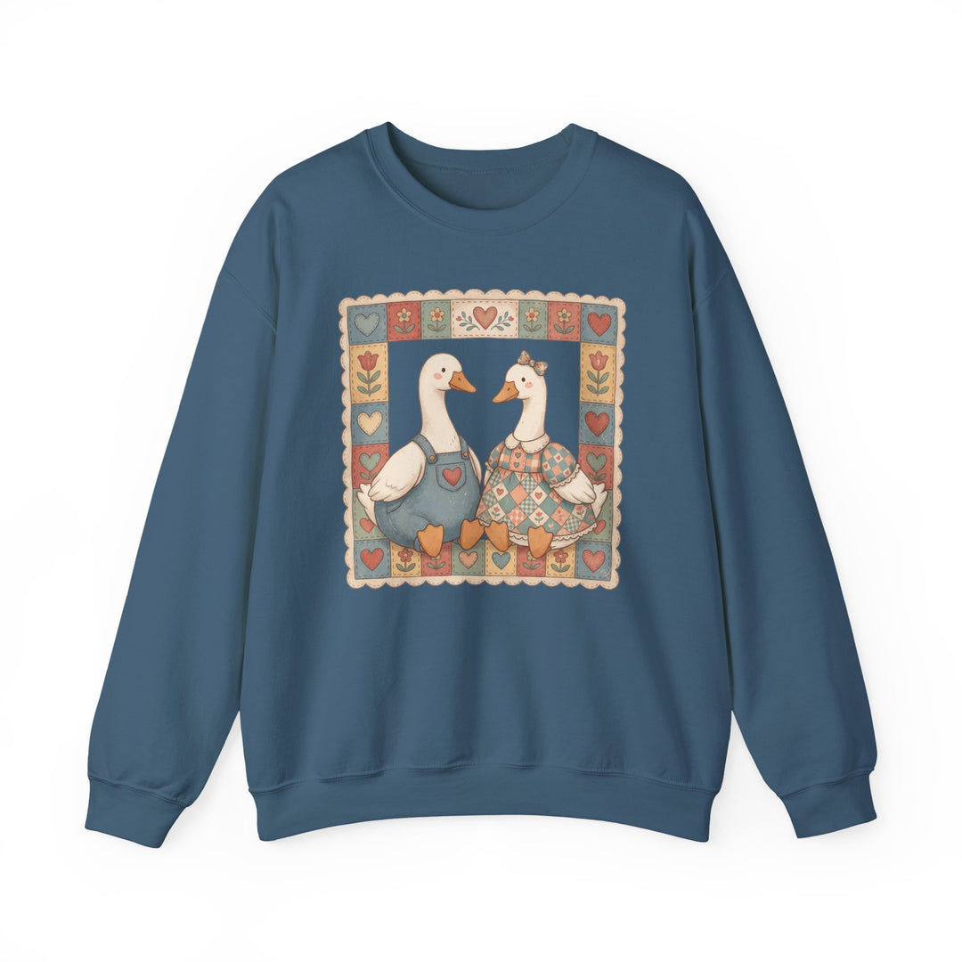 Thrifted Geese Crew sweatshirt featuring whimsical folk-art geese in charming attire, framed by heart and flower motifs, offering cozy comfort with a polyester-cotton blend.