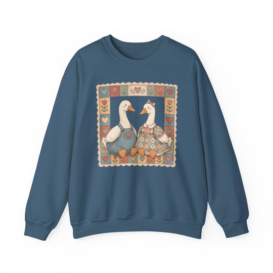 Thrifted Geese Crew sweatshirt featuring whimsical folk-art geese in charming attire, framed by heart and flower motifs, offering cozy comfort with a polyester-cotton blend.