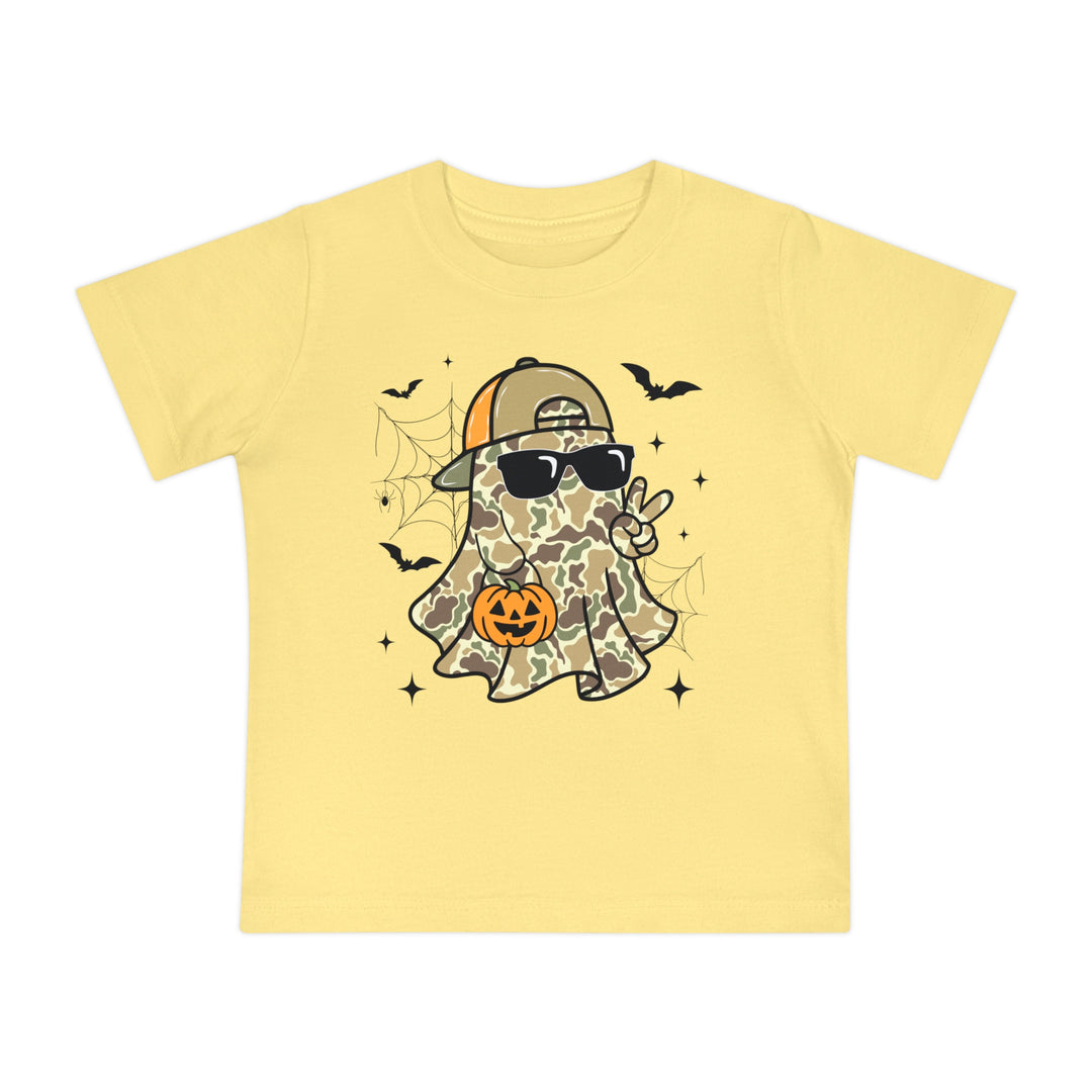 Candy Ghost Baby Tee: A playful Halloween-themed pale yellow children's T-shirt featuring a ghost with camouflage, sunglasses, and a candy bucket, surrounded by bats and spider-webs.