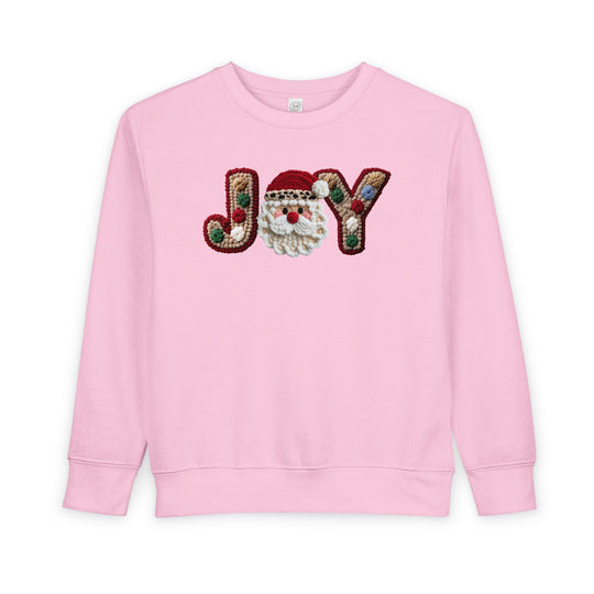Joy Toddler Crew: Light-pink sweatshirt with JOY featuring tufted letters and a fluffy Santa face, ensuring warmth and style for toddlers.
