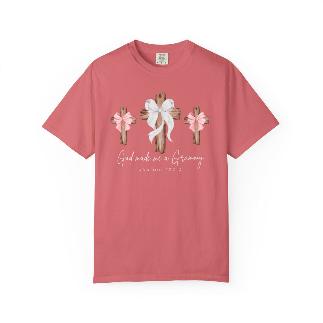 Coral-pink tee with three wooden crosses and bows, featuring God Made Me a Grammy and PSALMS 127:3. Relaxed fit, durable, customizable.