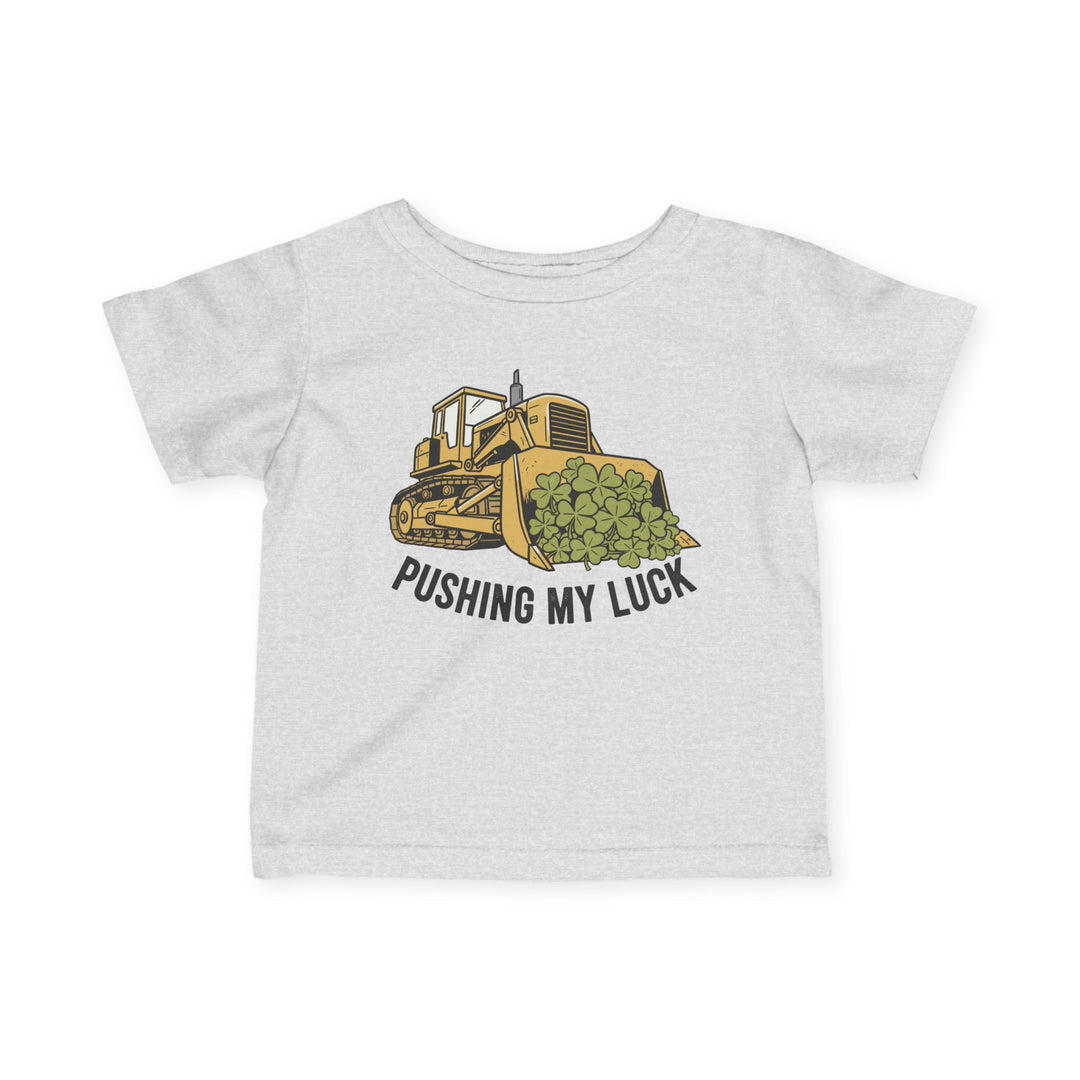 Light-gray children's T-shirt with cartoon bulldozer and clovers, captioned PUSHING MY LUCK. Durable, comfortable, 100% ring-spun cotton. Ideal for toddlers.
