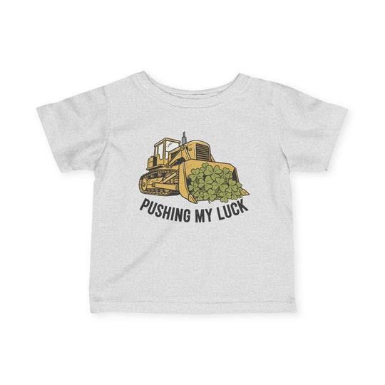 Light-gray children's T-shirt with cartoon bulldozer and clovers, captioned PUSHING MY LUCK. Durable, comfortable, 100% ring-spun cotton. Ideal for toddlers.