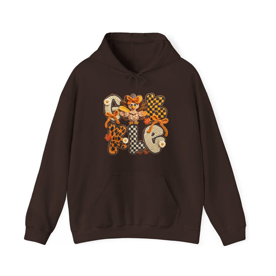 Gobble Hoodie features a dark-brown pullover design with a Thanksgiving motif, including chunky crochet-style GOBBLE letters, leaf accents, and a cartoon turkey.