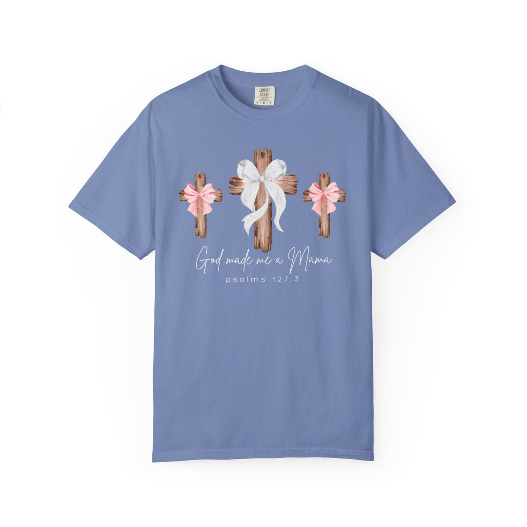 Pastel-blue T-shirt featuring three wooden crosses with bows and Psalms 127:3, God made me a Mama. Relaxed fit, 100% ring-spun cotton.