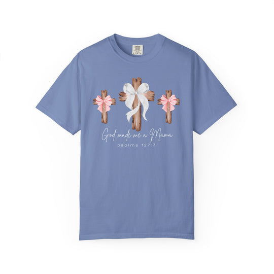 Pastel-blue T-shirt featuring three wooden crosses with bows and Psalms 127:3, God made me a Mama. Relaxed fit, 100% ring-spun cotton.