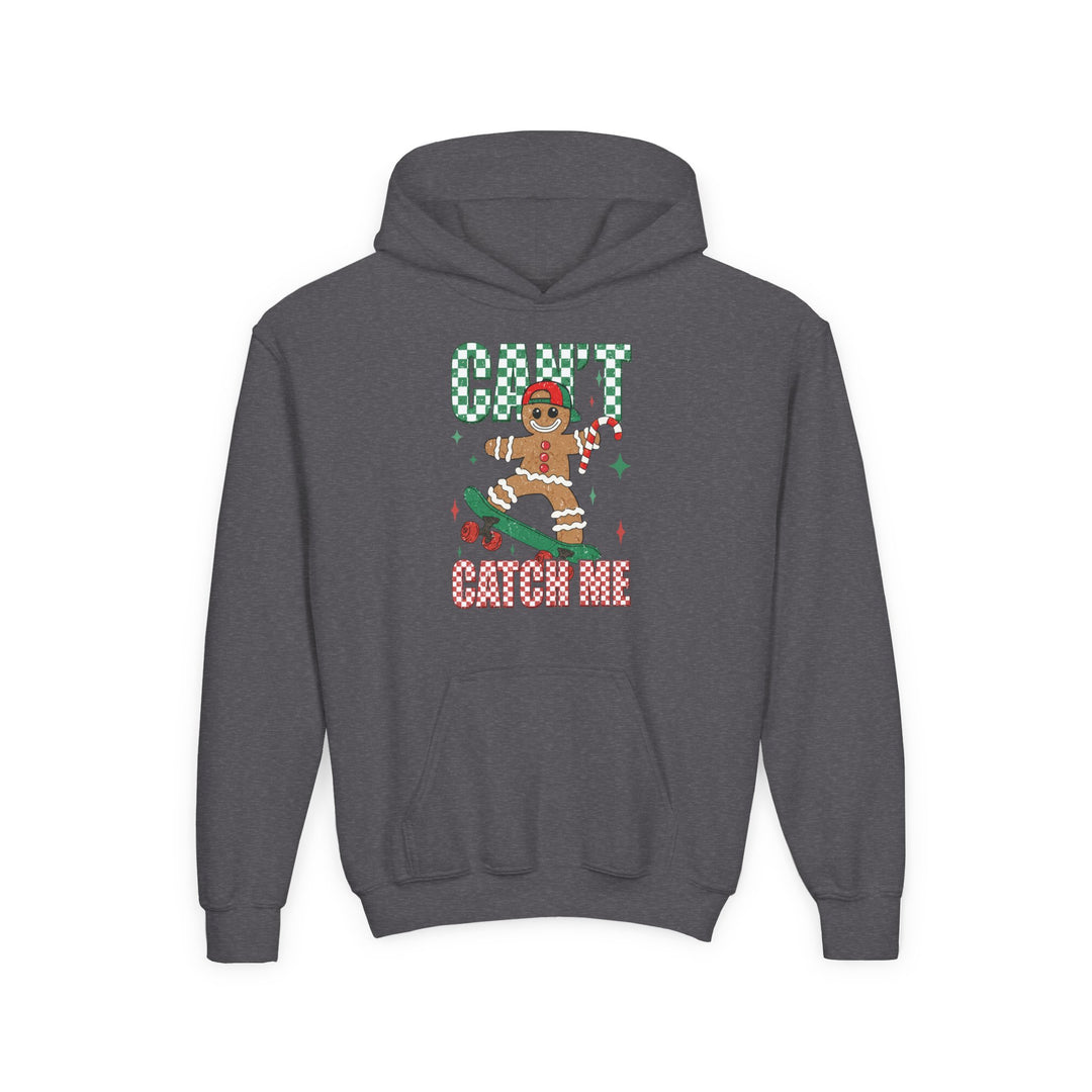 Can't Catch Me Youth Hoodie features a cartoon gingerbread man skateboarding with a candy cane, wearing a cap, surrounded by CAN’T CATCH ME in festive lettering.
