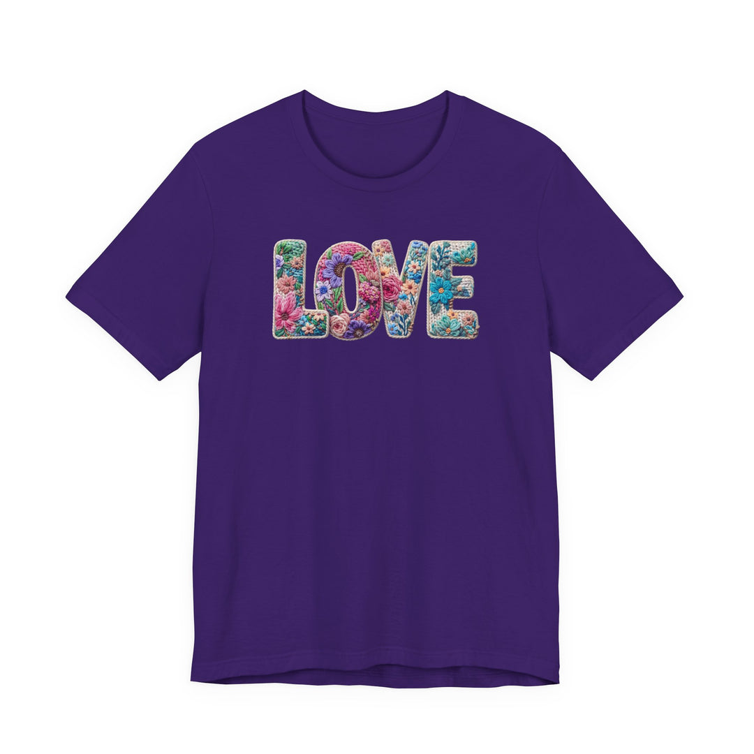 Love Spring Tee: Purple T-shirt with LOVE in vibrant, flower-studded letters, offering a soft, classic unisex fit from Faith Family Designs.