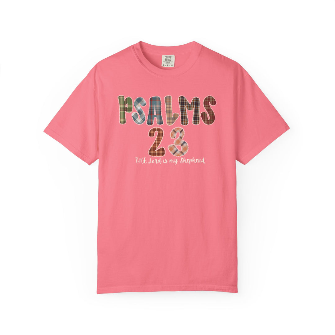 Coral-pink Psalms 23 Tee featuring a plaid patchwork graphic and script. Luxurious comfort with a relaxed fit, perfect for expressing faith and style.