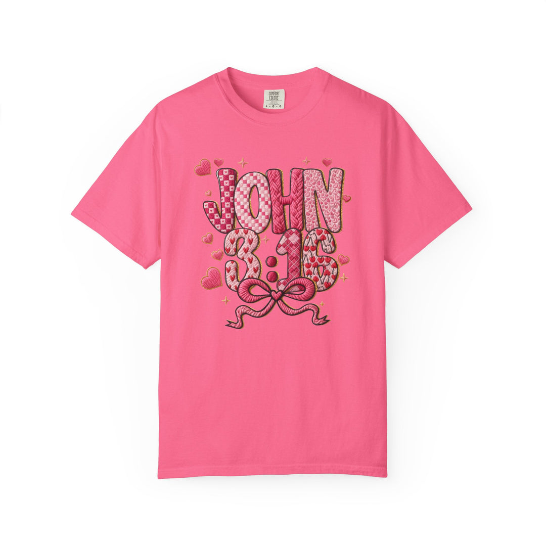 Bright pink 3:16 Tee with JOHN 3:16 in patchwork-style letters, featuring heart patterns and sparkles, perfect for stylish, faith-inspired wear.