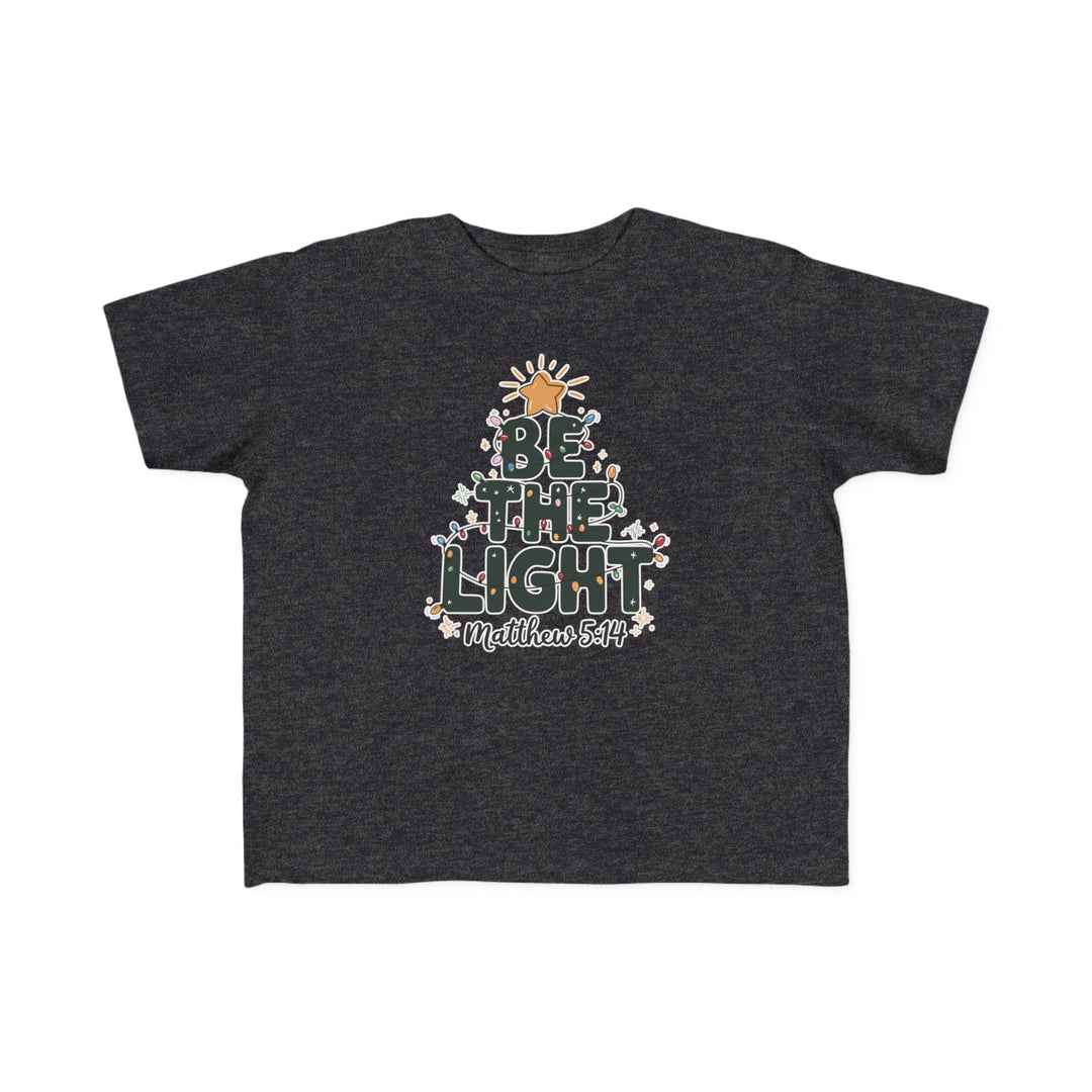 Be the Light Toddler Tee featuring a tree-shaped BE THE LIGHT graphic with Christmas lights, snowflakes, and Matthew 5:14 reference, ideal for sensitive skin.