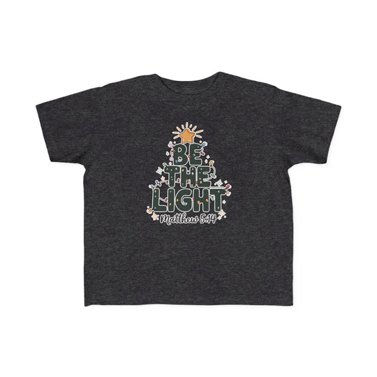 Be the Light Toddler Tee featuring a tree-shaped BE THE LIGHT graphic with Christmas lights, snowflakes, and Matthew 5:14 reference, ideal for sensitive skin.