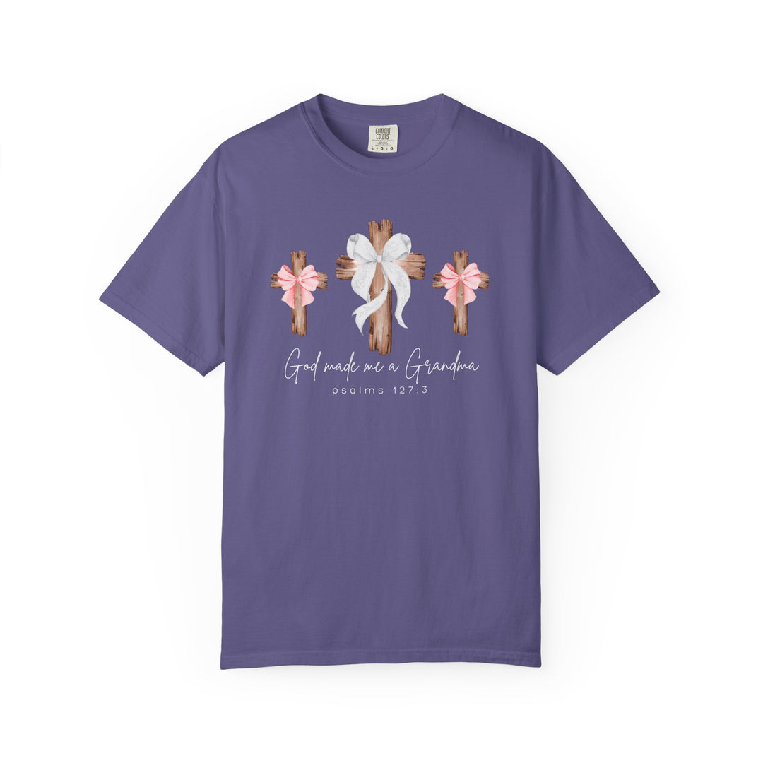 Purple T-shirt featuring three rustic wooden crosses with bows, text God made me a Grandma, and Psalms 127:3, capturing a heartfelt, faith-centered design.