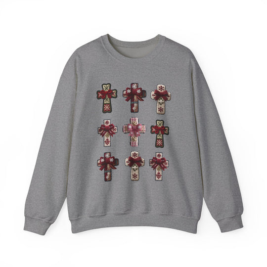 Heather-gray crewneck sweatshirt with a grid of decorative cross shapes featuring holiday motifs and red bows, showcasing Faith Family Designs' unique style.