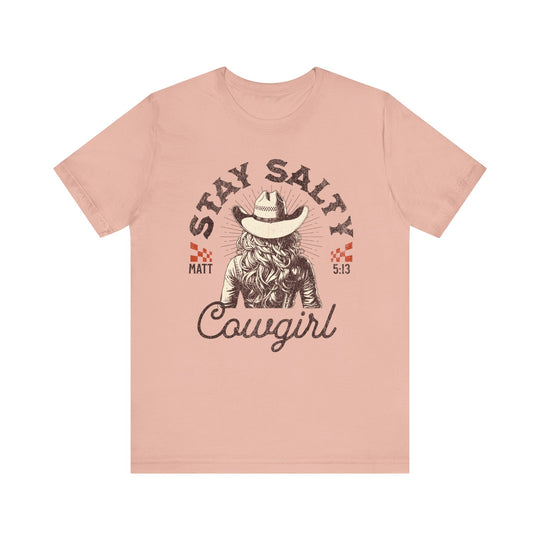 Stay Salty Tee: Pink short sleeve t-shirt featuring a cowboy hat and cowgirl graphic. Soft cotton fabric with ribbed knit collars for lasting shape.