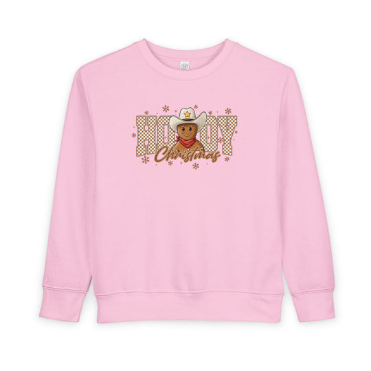 Light-pink toddler crewneck with a cowboy gingerbread design and Howdy Christmas in buffalo-check, featuring snowflakes. Cozy, soft fleece blend, ideal for festive comfort.