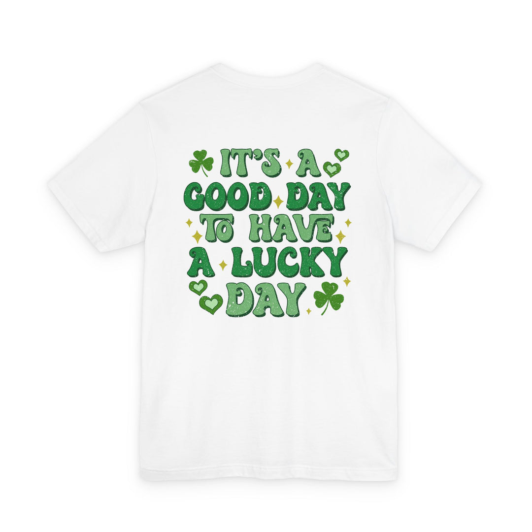 Good Day Lucky Day Tee with green playful lettering and four-leaf clovers evokes a festive theme. Unisex fit, soft cotton, durable design.