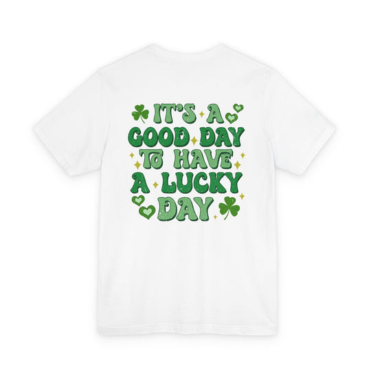 Good Day Lucky Day Tee with green playful lettering and four-leaf clovers evokes a festive theme. Unisex fit, soft cotton, durable design.