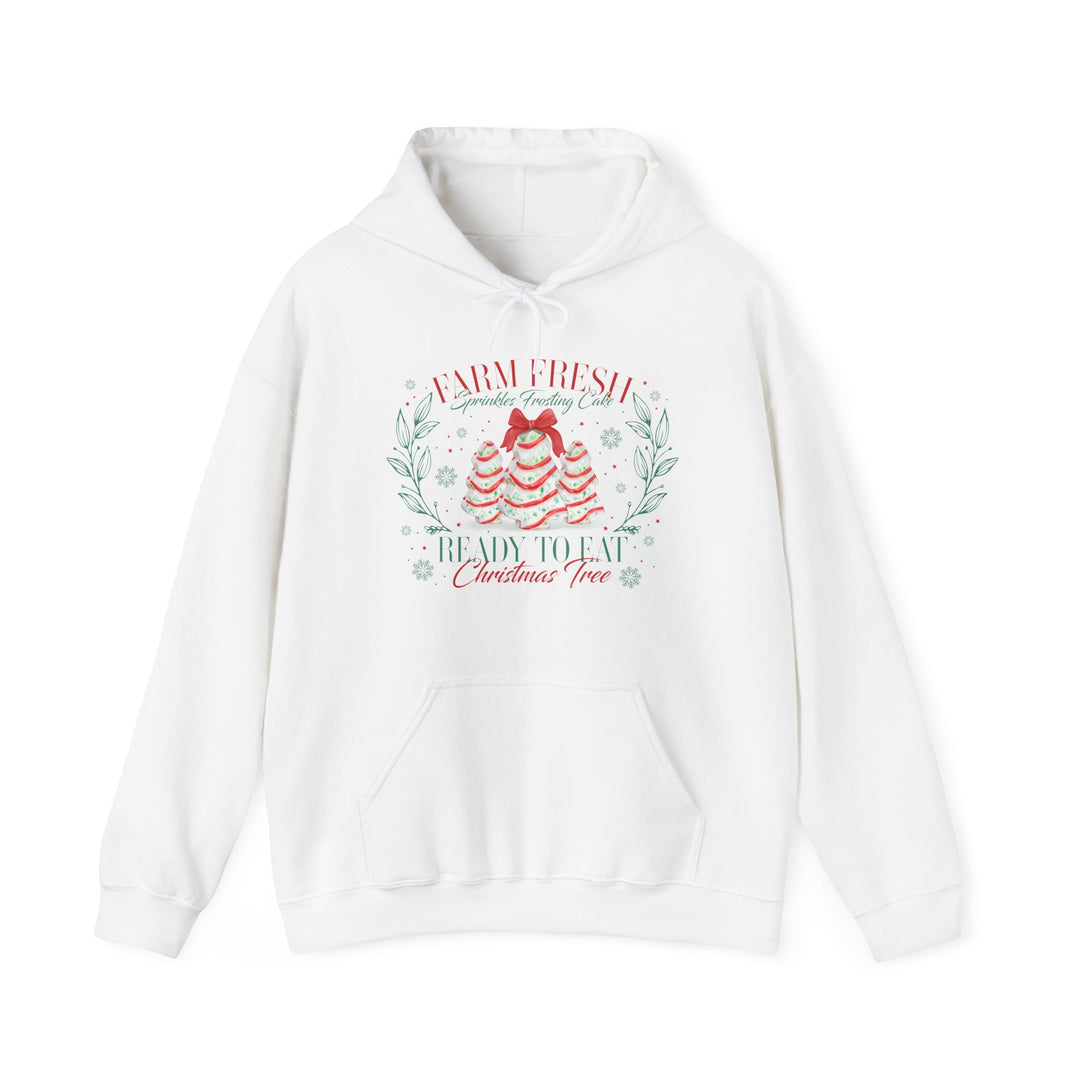 White hoodie featuring festive Christmas Cookies Hoodie design with frosting tree graphics, red bow, greenery, and snowflakes, perfect for cozy holiday wear.