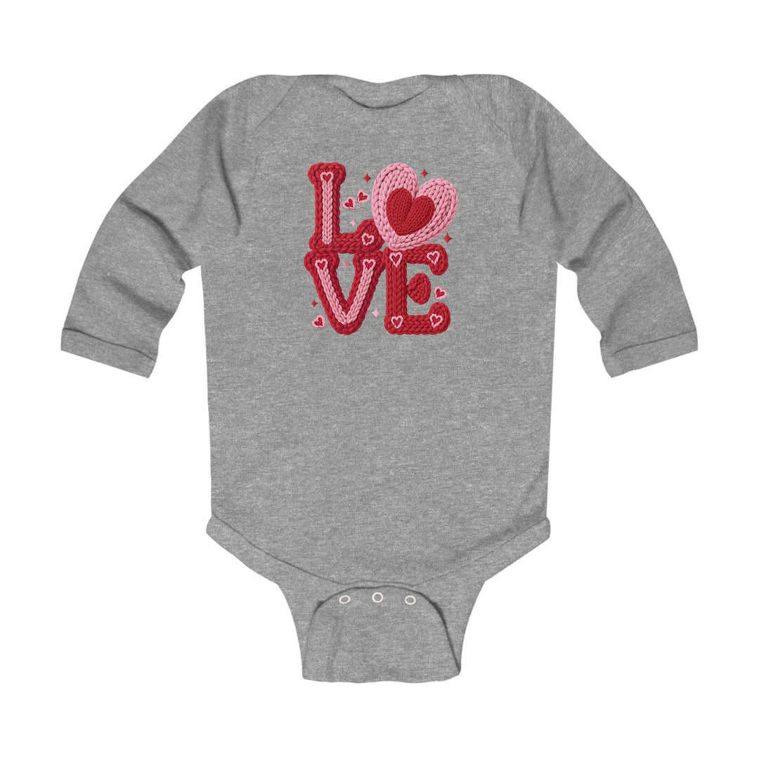 Love Heart Onesie: Gray long-sleeve baby bodysuit with LOVE graphic in knitted-yarn style, featuring crotch snap closures for easy changing. Soft, durable fabric.