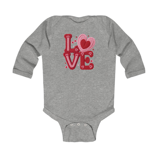 Love Heart Onesie: Gray long-sleeve baby bodysuit with LOVE graphic in knitted-yarn style, featuring crotch snap closures for easy changing. Soft, durable fabric.