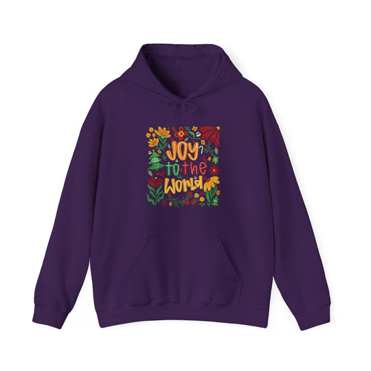 Deep purple Joy to the World hoodie with colorful holiday-themed design, featuring flowers, holly, Christmas trees, and gifts. Includes kangaroo pocket and drawstring hood.