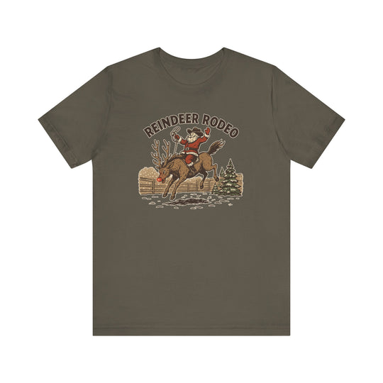 Reindeer Rodeo Tee featuring Santa riding Rudolph in a snowy corral, playful Christmas design on an olive-green unisex, soft cotton T-shirt.