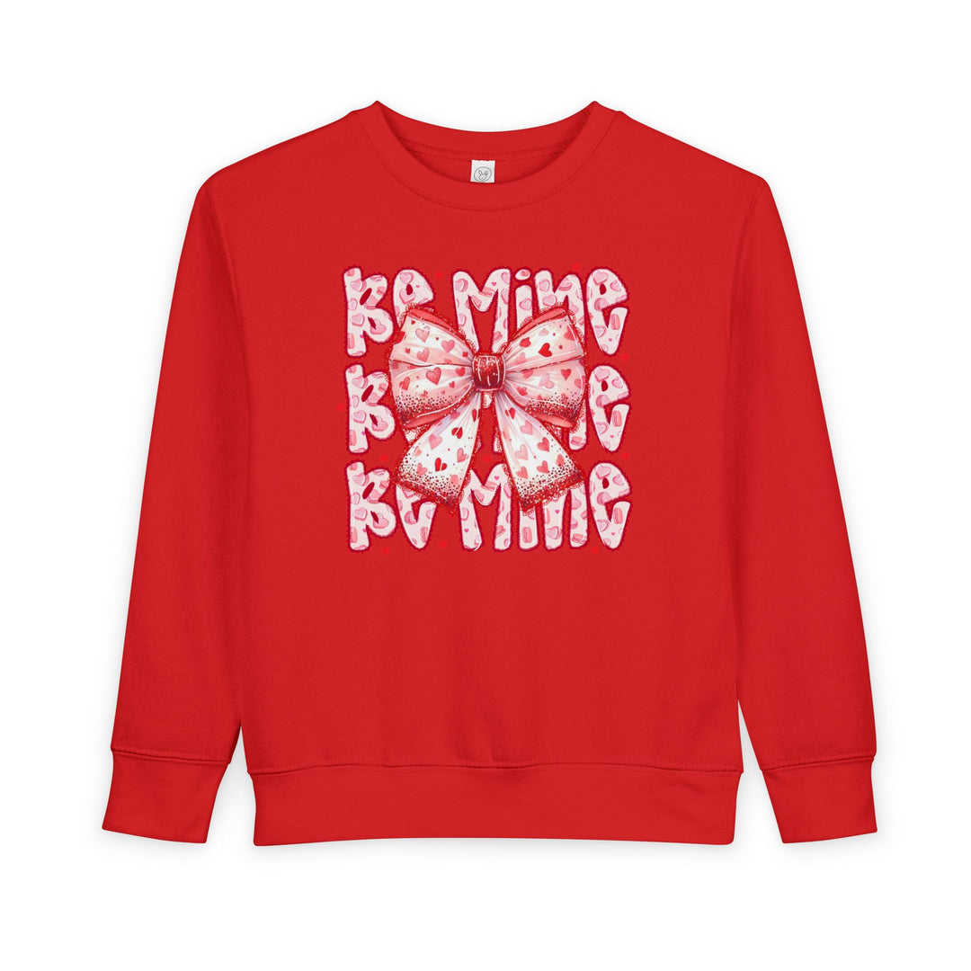Be Mine Toddler Crew: Bright red sweatshirt with a pink heart-patterned bow and BAMING motif, designed for warmth and style.