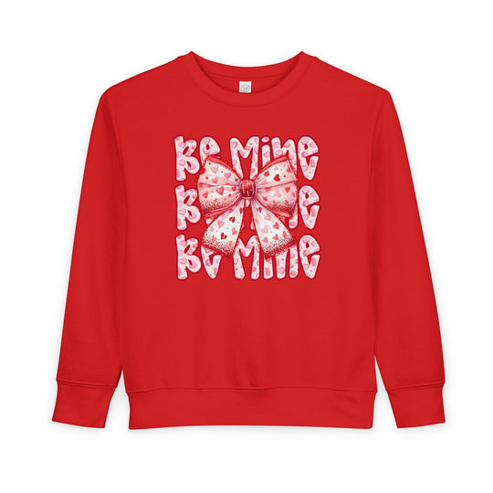 Be Mine Toddler Crew: Bright red sweatshirt with a pink heart-patterned bow and BAMING motif, designed for warmth and style.