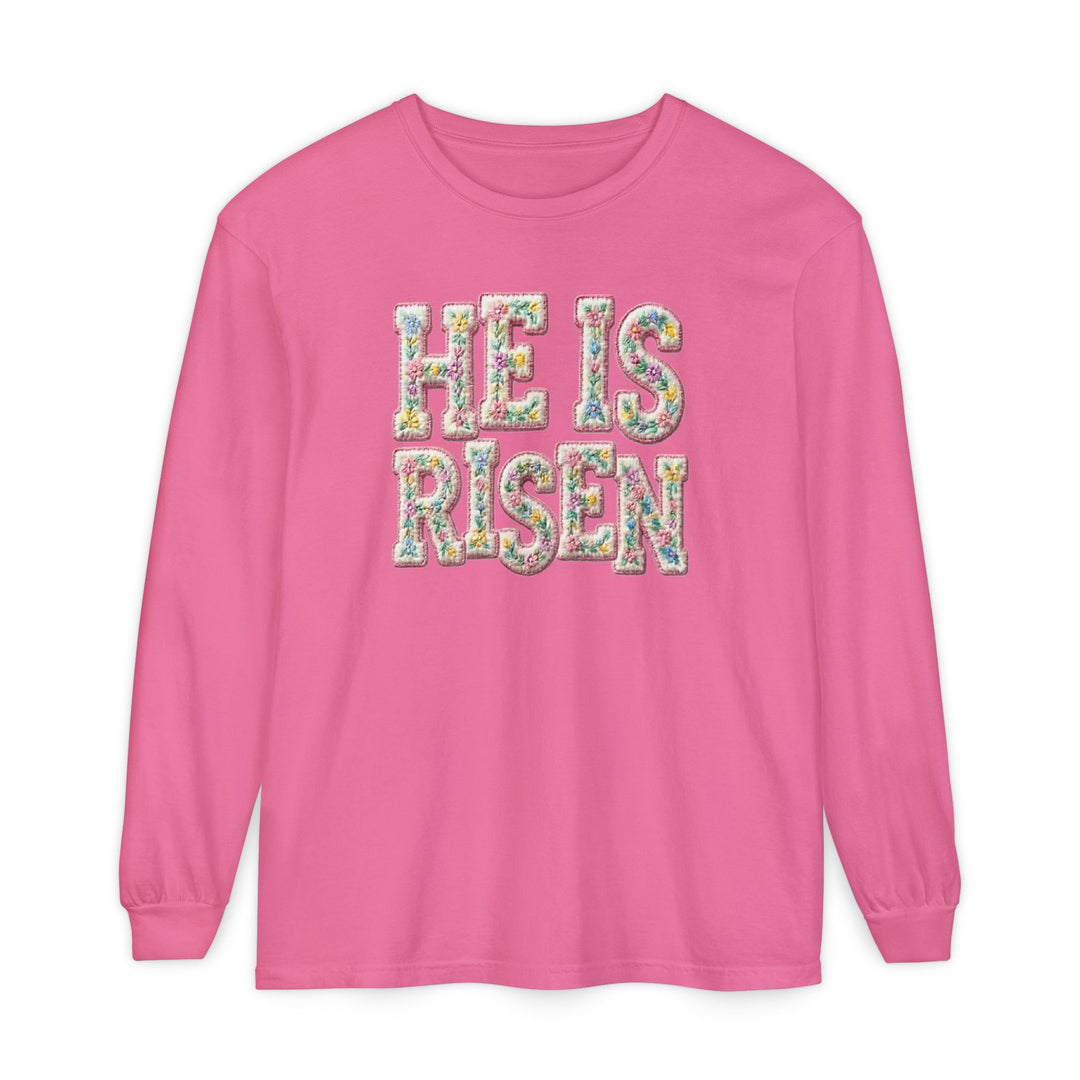 He is Risen Long Sleeve Tee features pastel floral letters on pink, 100% cotton, offering a soft, relaxed fit perfect for casual, spring settings.