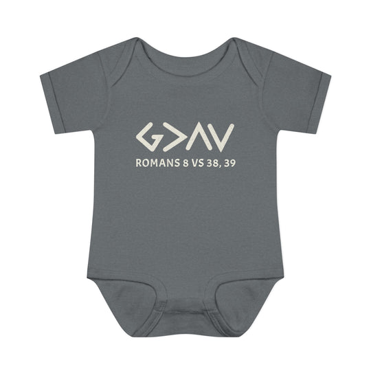 Grey baby bodysuit with God is Greater in white text, featuring lap shoulders and made from soft, 100% combed ringspun cotton for infant comfort.