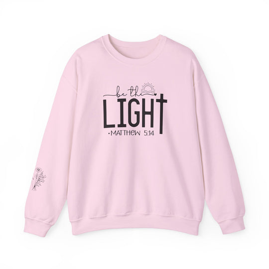A unisex heavy blend crewneck sweatshirt, the Be the Light Crew, offers comfort and durability. Made of 50% cotton and 50% polyester, featuring a ribbed knit collar and double-needle stitching for a classic fit.