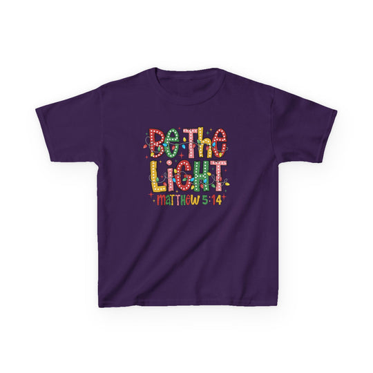 Purple kids' tee with 'Be the Light' graphic in marquee-style letters and 'Matthew 5:14' below, ideal for everyday wear.