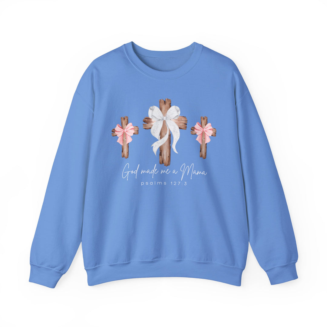 God Made Me a Girl Mama Crew: Light-blue sweatshirt with rustic wooden crosses and bows graphic, featuring spiritual text. Unisex, comfortable polyester-cotton blend, ribbed collar, no side seams.