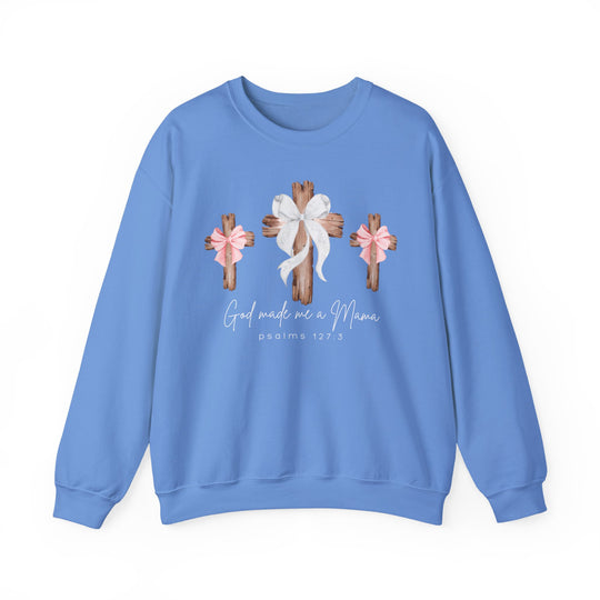 God Made Me a Girl Mama Crew: Light-blue sweatshirt with rustic wooden crosses and bows graphic, featuring spiritual text. Unisex, comfortable polyester-cotton blend, ribbed collar, no side seams.