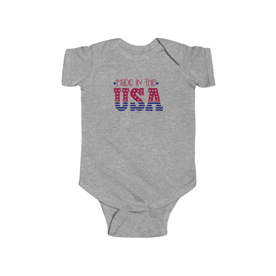 Made in the USA Onesie, grey bodysuit with red and blue text, 100% cotton, ribbed knit bindings, plastic snaps, infant fine jersey bodysuit, tear away label, light fabric, durable seams, sizes NB to 24M.