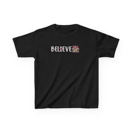 Believe Kids Tee featuring a Christmas graphic with BELIEVE in white, candy-cane motif, and gingerbread-house illustration on a black short-sleeve T-shirt.