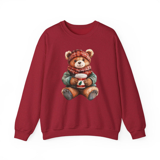 Old Money Bear Crew: Red sweatshirt featuring a teddy bear in a plaid hat and scarf, holding a festive cup, offering cozy comfort and unique style.