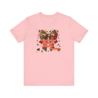 Light-pink Gift from Above Tee featuring a patchwork-style holiday bow with Bible verse James 1:17, surrounded by festive motifs.