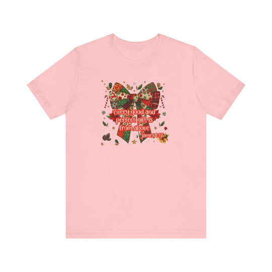 Light-pink Gift from Above Tee featuring a patchwork-style holiday bow with Bible verse James 1:17, surrounded by festive motifs.