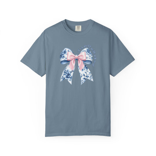 It is Well With My Soul Tee featuring a denim-blue color with a large bow graphic and inspirational text, offering a relaxed fit and luxurious comfort.